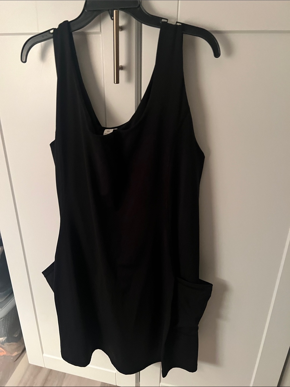 Black Sleeveless Pocket dress with shorts underneath with side pockets.